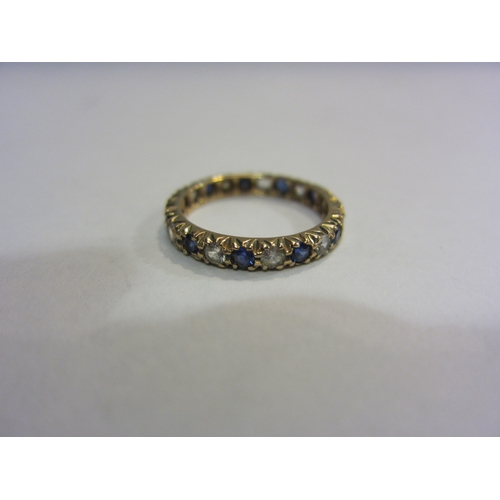 4334 - A gold eternity ring with sapphires and clear stones