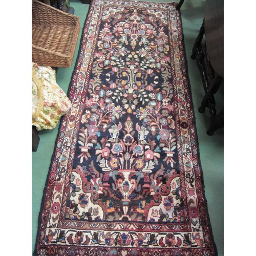 4130 - An Iranian wool rug with foliate design, multiple borders, 250cm x 100cm