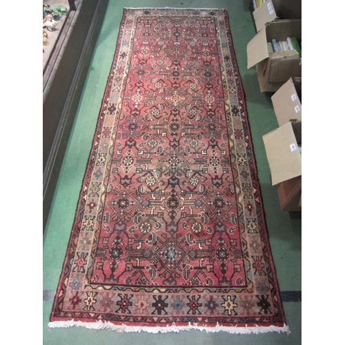 4180 - A Persian handmade wool rug with geometric design, 276cm x 100cm