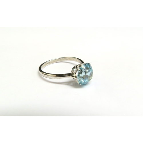 8077 - A white gold blue zircon ring, stamped 9ct. Size O, 2.3g