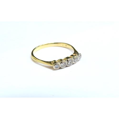 8042 - A gold ring with five graduated diamonds in rubover setting, stamped 18ct. Size R, 2.2g