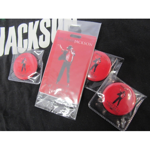 7290 - MICHAEL JACKSON: A 1988 'Bad' tour t-shirt together with three 2009 'This Is it' tour badges and pla... 