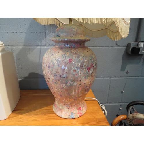 1044 - A ceramic table lamp decorated with flowers and butterflies, tasselled shade