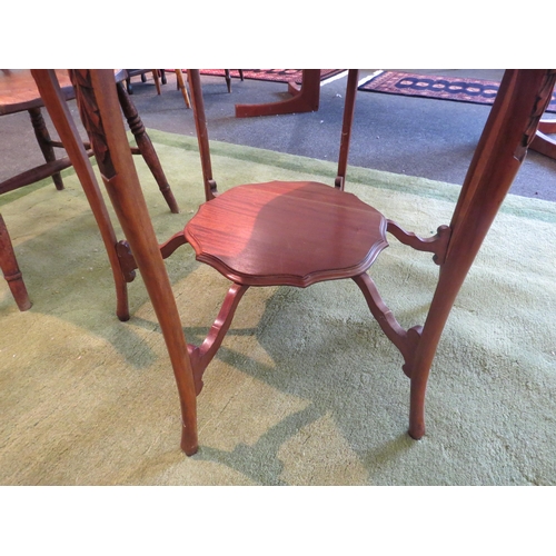 1143 - An Edwardian walnut occasional table with piecrust top, carved knees to an under-tier, 70cm tall x 7... 