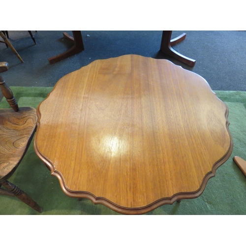 1143 - An Edwardian walnut occasional table with piecrust top, carved knees to an under-tier, 70cm tall x 7... 