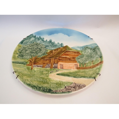 1173 - A West German wall hanging charger depicting a wooden chalet, 41cm diameter, a large piggy bank and ... 