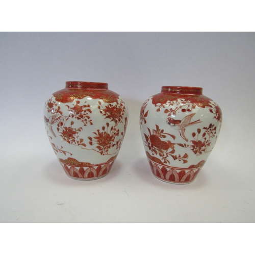 1327 - A pair of Japanese Kutani vases, white ground with orange floral sprays enriched with gilt, 13cm tal... 