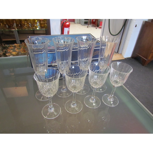 1447 - A set of four crystal champagne flutes and four matching small wine glasses