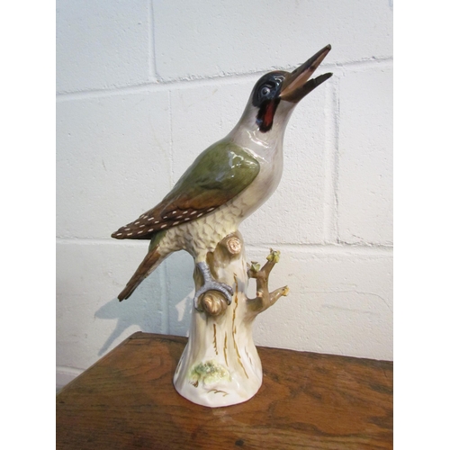 1008 - A Meissen figure of a green woodpecker, beak damaged, 27cm tall       (R) £30