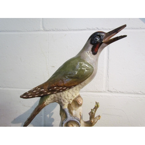 1008 - A Meissen figure of a green woodpecker, beak damaged, 27cm tall       (R) £30