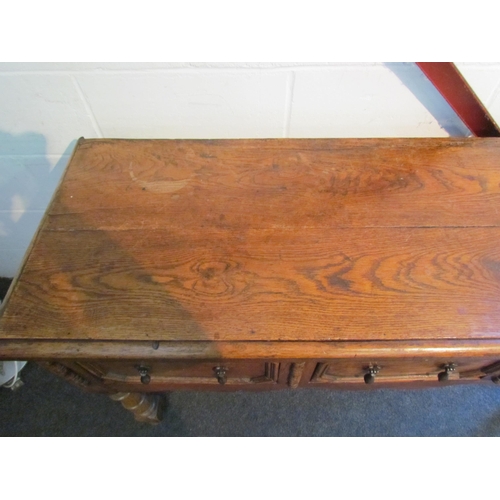 1009 - A Jacobean style oak dresser base, three drawers with geometric moulding, turned fore legs, 81cm tal... 