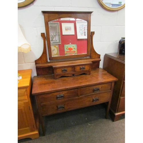 1039 - A late 19th Century oak Art Nouveau dressing table with mirrored top over jewellery drawers, two sho... 