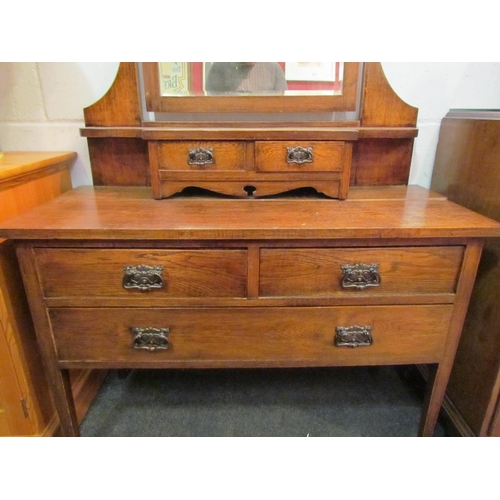 1039 - A late 19th Century oak Art Nouveau dressing table with mirrored top over jewellery drawers, two sho... 