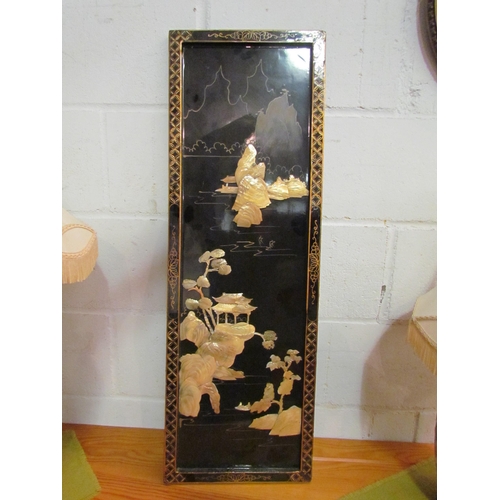 1043 - A Japanese lacquered panel with high relief mother-of-pearl detail, 91.5cm x 31cm              (E) £... 