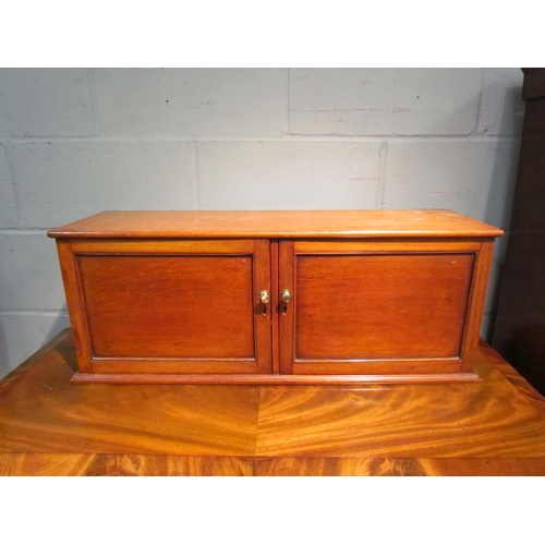 1051 - An early 20th Century mahogany two door cupboard, 31cm tall x 81cm wide x 24cm deep