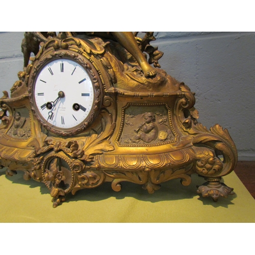 1077 - A gilt metal mantel clock. Henry Marc Paris dial. Decorated with huntsman, hound and pheasant. 35cm ... 