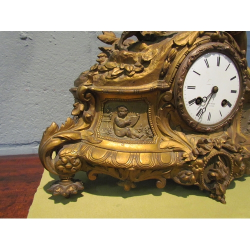 1077 - A gilt metal mantel clock. Henry Marc Paris dial. Decorated with huntsman, hound and pheasant. 35cm ... 