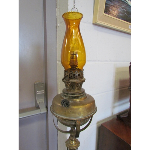 1084 - WITHDRAWN - An early 20th Century brass standard lamp converted to electric, amber glass chimney, 15... 