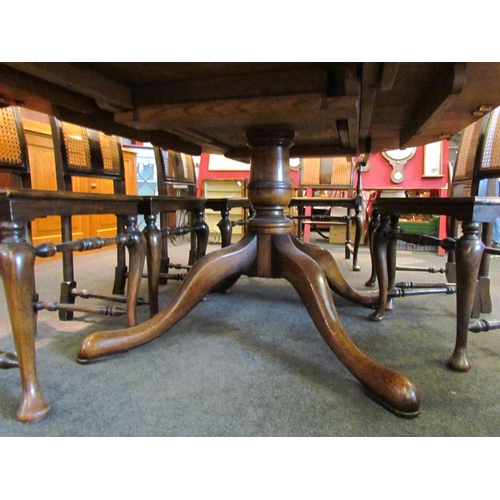 1086 - An oak extending dining table with two extra leaves, vase form column on four legs, 75cm tall x 228c... 