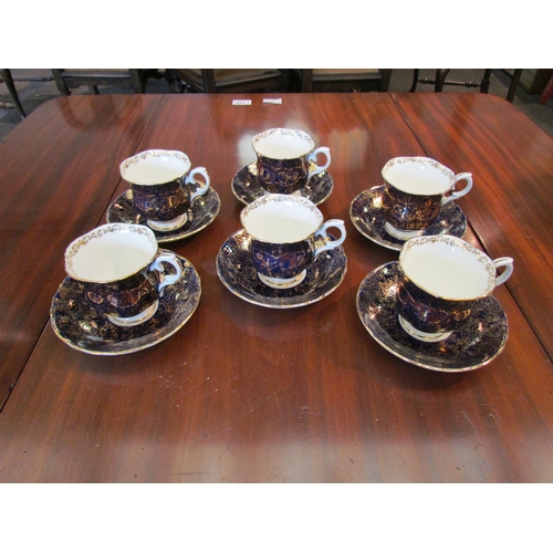 1090 - A Crown Staffordshire six place cup and saucer set, cobalt blue and gilt design