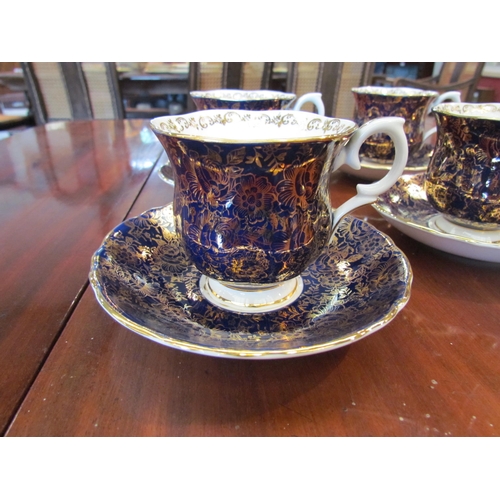 1090 - A Crown Staffordshire six place cup and saucer set, cobalt blue and gilt design