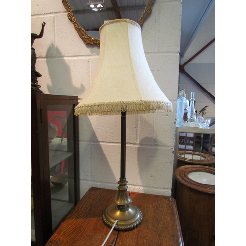 1093 - A Victorian brass table lamp of column form with tasselled ends