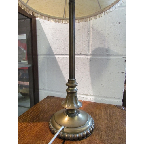 1093 - A Victorian brass table lamp of column form with tasselled ends