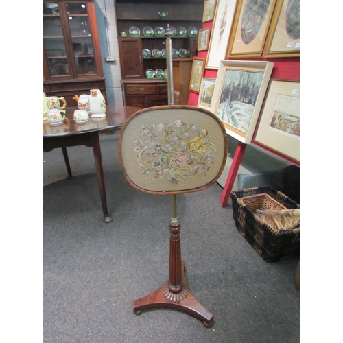 1095 - A William IV mahogany pole screen, the brass pole with needlepoint floral design, on a melon fluted ... 