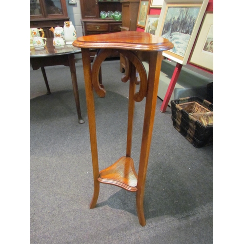 1096 - A mahogany slender jardinière stand with under-tier, 93cm tall