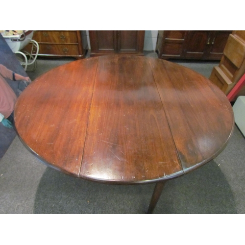 1098 - A Georgian mahogany drop-leaf circular top dining table,  71cm tall x 122cm long x 110cm wide