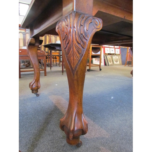 1126 - A circa 1900 oak extending dining table with round cornered top, on carved cabriole legs to ball and... 