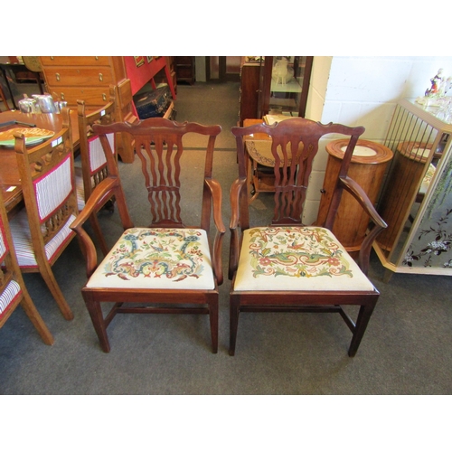 1022 - A pair of Georgian revival mahogany armchairs, the wavy slat backrest over a decorative and 