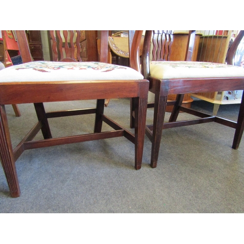 1022 - A pair of Georgian revival mahogany armchairs, the wavy slat backrest over a decorative and 