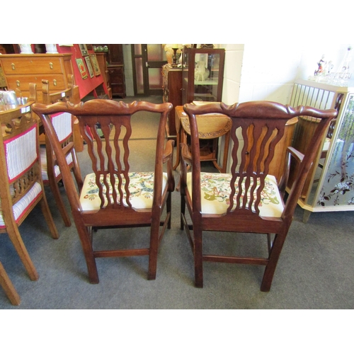 1022 - A pair of Georgian revival mahogany armchairs, the wavy slat backrest over a decorative and 