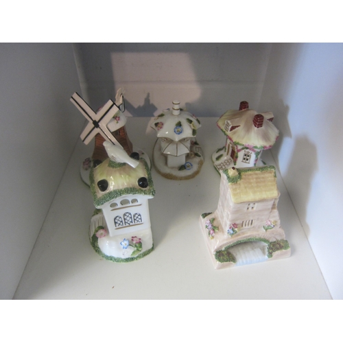 1351 - Five Coalport ceramic cottages and pastel burners