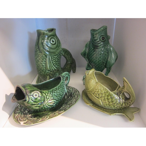 1366 - Four green fish ceramics including jug, sauce boat, etc.