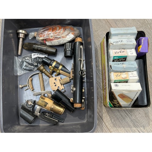 7023 - A quantity of instrument accessories including violin parts, reeds and saxophone accessories