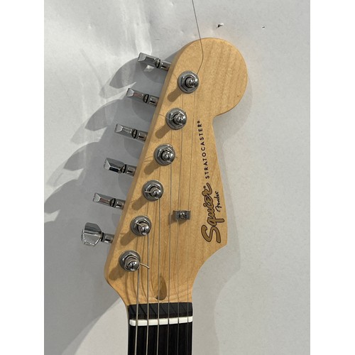 7092 - A Fender Squier electric guitar, ivory coloured body, cased, serial number CMY118000902