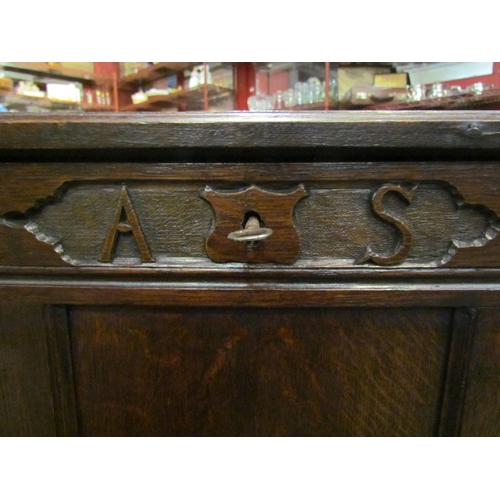4003 - An 18th Century revival oak three panel coffer, the hinged lid with carved relief front over stile f... 