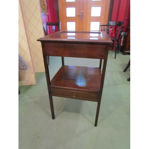 4038 - A Georgian mahogany two tier bijouterie table, the hinged glazed top and velvet interior on square l... 