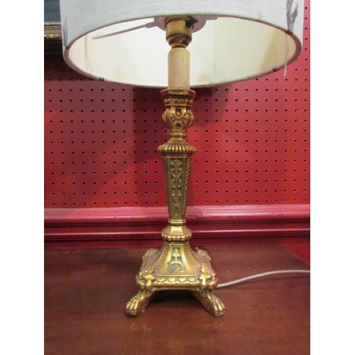 4045 - An ornate gilt table lamp with shade depicting stags