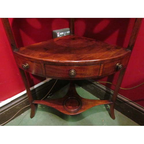 4048 - A George III mahogany three tier corner washstand the raised back with candle shelf over a single dr... 