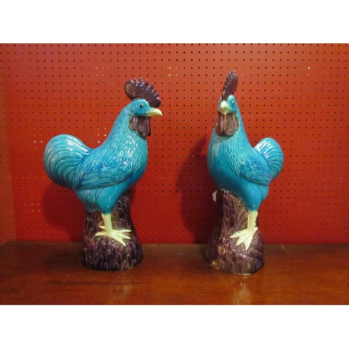 4059 - A pair of Oriental turquoise cockerels, beaks chipped, 42cm tall