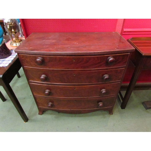 4072 - An early to mid 19th Century mahogany bow front chest of four graduating long drawers with bun handl... 