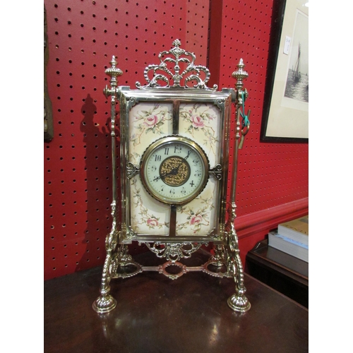 4086 - A mantel clock, ornate brass frame and ceramic tile with floral decoration holding platform timepiec... 