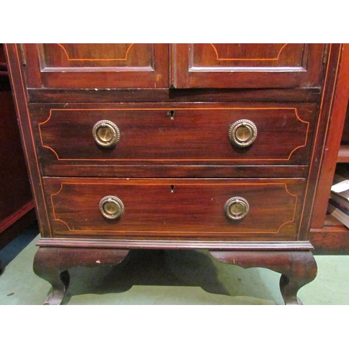 4087 - An Edwardian mahogany cabinet, the twin doors inlaid with marquetry swags, over two long drawers, ca... 