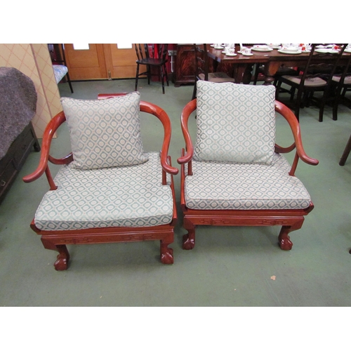 4101 - A pair of Chinese carved teak horseshoe armchairs with Greek key frieze over ball in claw cabriole f... 