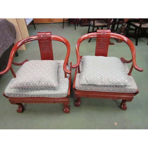 4101 - A pair of Chinese carved teak horseshoe armchairs with Greek key frieze over ball in claw cabriole f... 