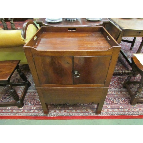 4109 - A George III mahogany nightstand with fret handle raised gallery over a two door cupboard and base d... 