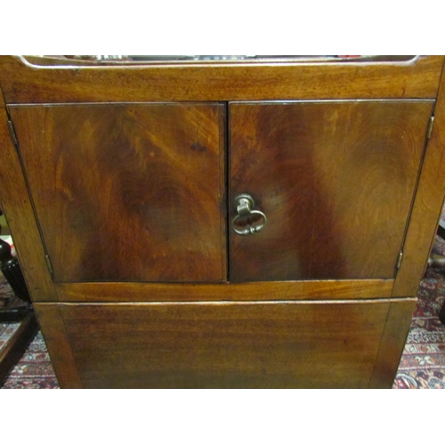 4109 - A George III mahogany nightstand with fret handle raised gallery over a two door cupboard and base d... 